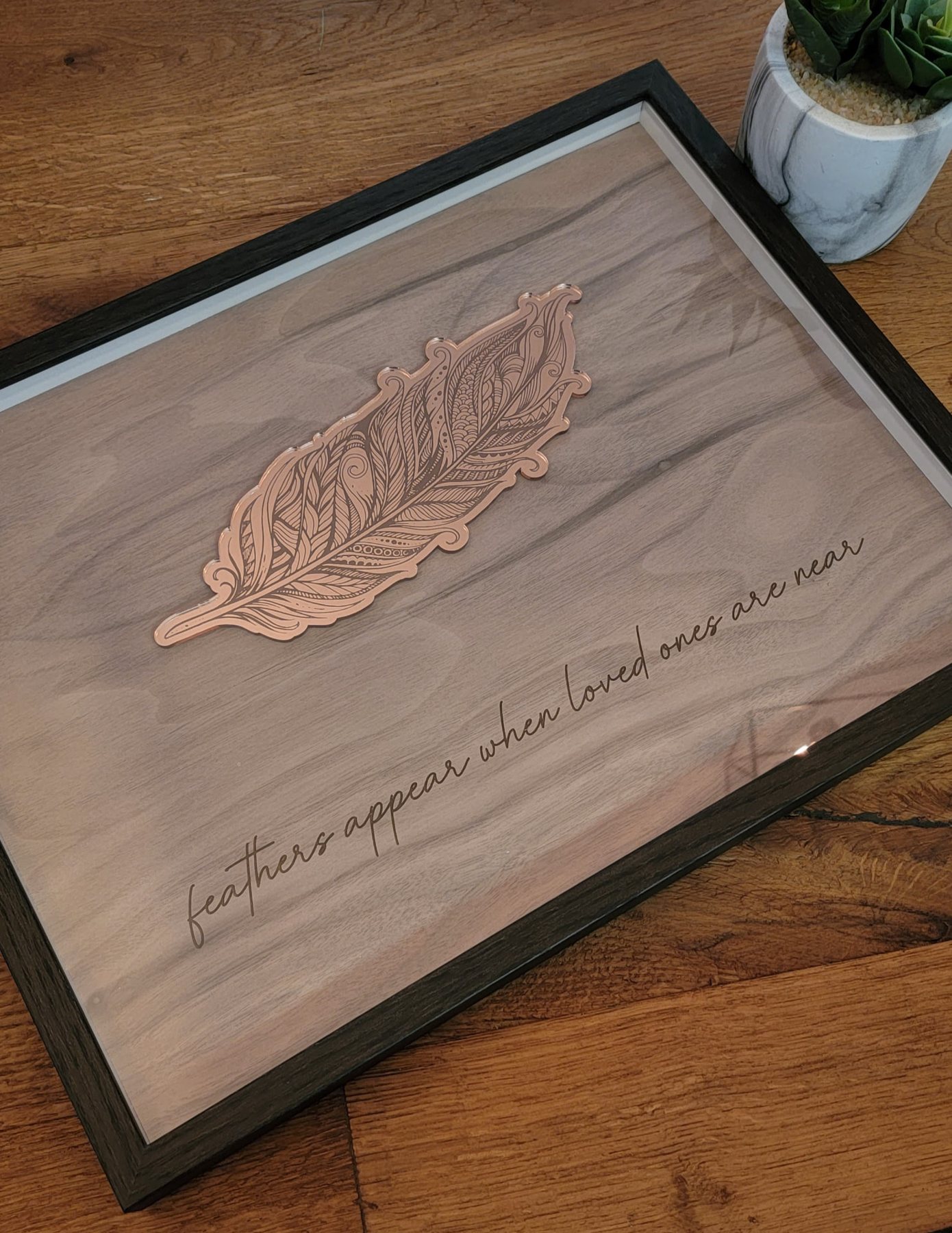 Framed walnut memorial piece with rose mirror feather and script quote