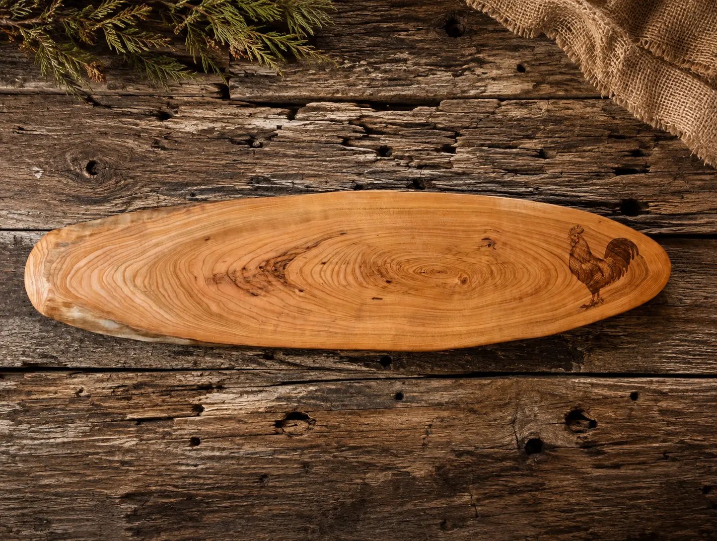 Live-edge cherry serving board with engraved rooster