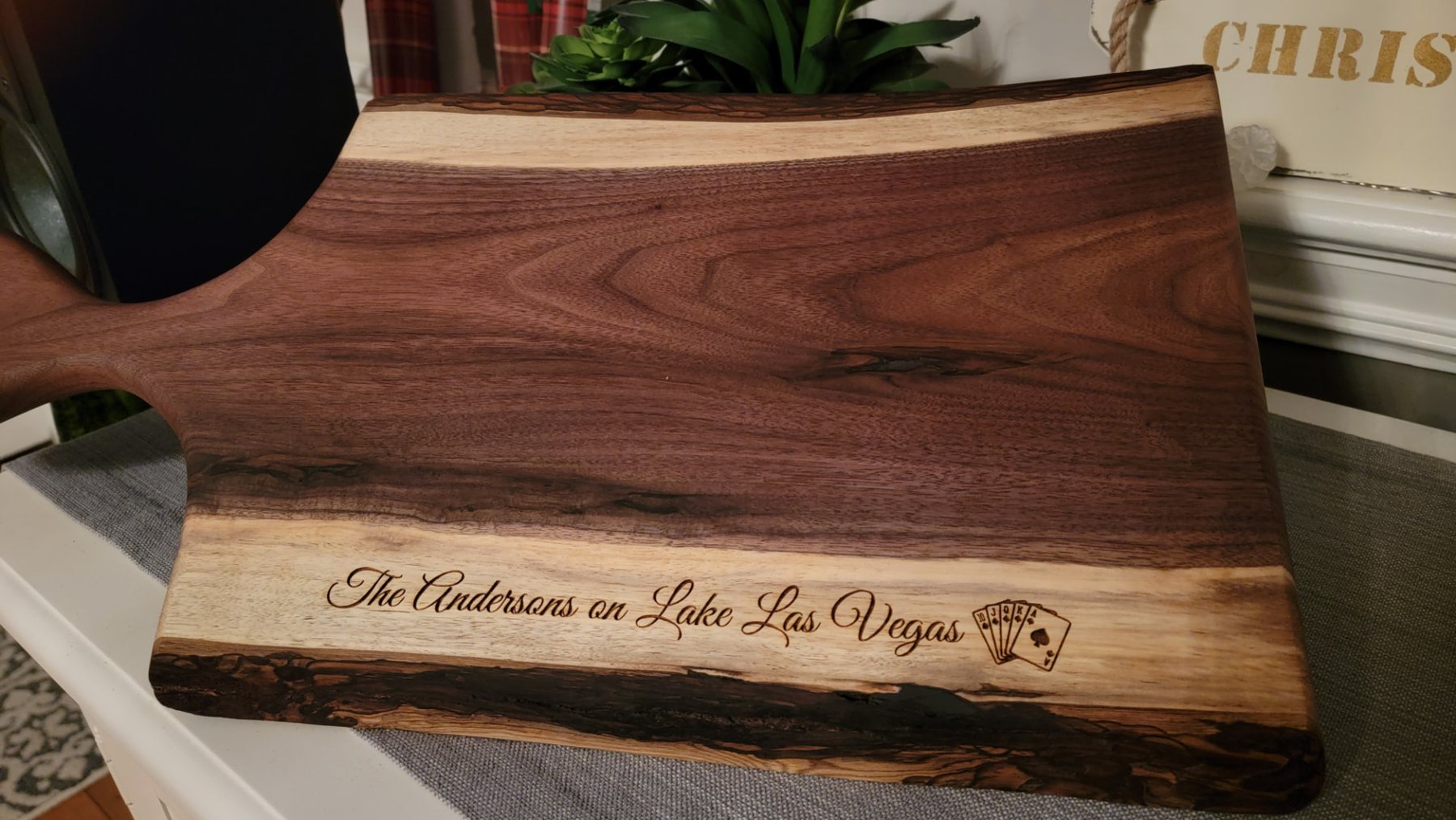 Live-edge walnut charcuterie board engraved The Andersons on Lake Las Vegas